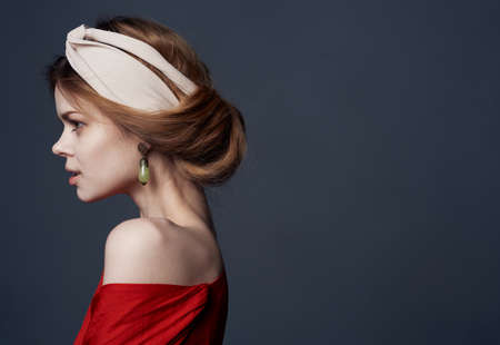 beautiful woman with a turban on her head attractive look red dress close-upの写真素材