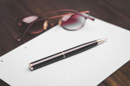 notebook and pen on a wooden table coffee cup flower in a pot top viewの写真素材