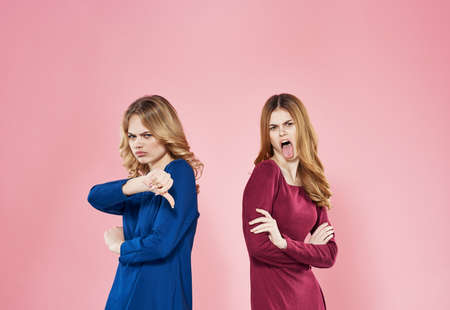 two elegant women communication lifestyle studio friendship pink backgroundの写真素材