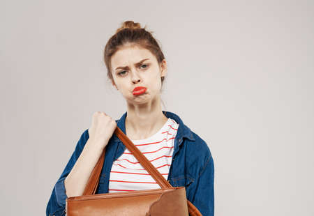 Cheerful young woman in fashion clothes backpack student teaching teenagerの写真素材