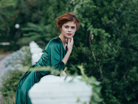 Pretty woman in green dress nature romance walk glamorの写真素材