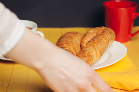 croissants plates wooden table drink mug breakfast dessert