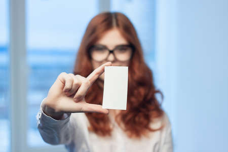 cheerful business woman holding a business card office executive financial coffee spaceの写真素材