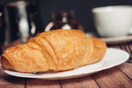 croissants in a plate a cup with a drink a meal dessert snackの写真素材