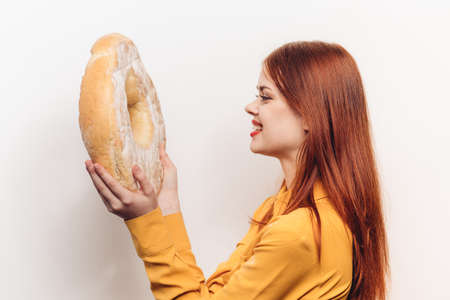 flour product round loaf of bread and emotional woman in yellow shirtの写真素材