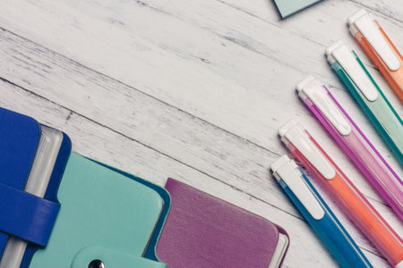 multicolored business card holders on a wooden table and markers pencils stationery pensの写真素材