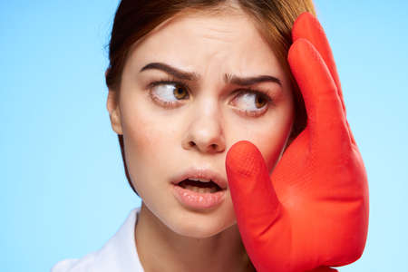 pretty woman close-up rubber glove near face podiatry workの写真素材