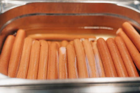 sandwich on a wooden table and boiled sausages pan cooking hot dogの写真素材