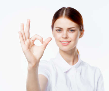 woman in white shirt strict style fashion emotions light backgroundの写真素材