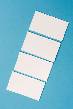 white business cards mockup placed randomly on the office desk