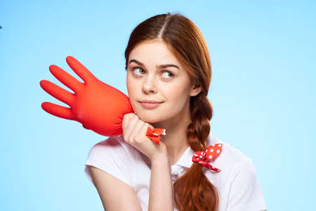 cleaning lady with inflated rubber glove in hand lifestyle fun