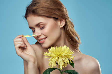 girl with flowers cropped view portrait close-up spring bare shoulders clear skin Make Up