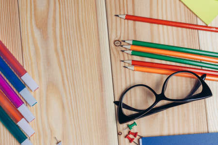 wooden work table stationery colorful markers school objects