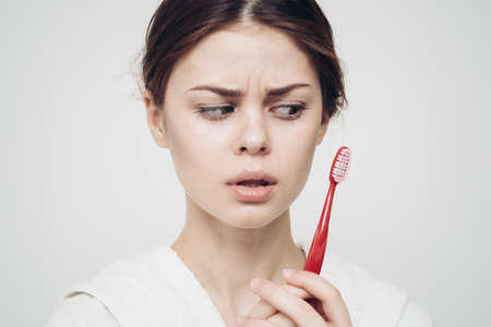 pretty woman toothbrush in hand in the morning oral hygiene