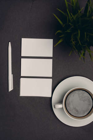 white business cards on dark table and office finance
