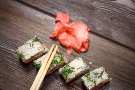 with sushi chopsticks ginger delicacy wooden background mealの写真素材