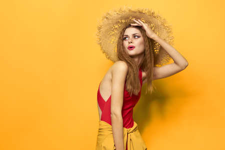 Woman in straw hat bright makeup summer lifestyle fun yellow background