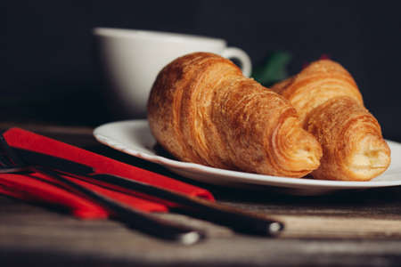 croissants on a white plate red coffee mugの写真素材