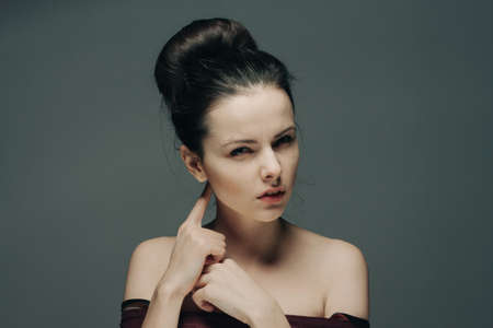woman with bare shoulders gesturing with hands hairstyle and emotions model