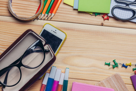 glasses cases colorful pencils Stationery on a wooden tableの写真素材