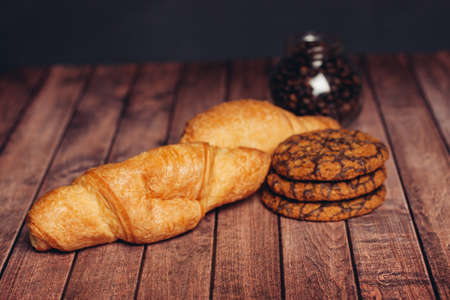 miscellaneous cookies sweets a cup of tea on a wooden table eatingの写真素材