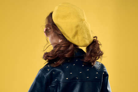 Girl in a yellow hat dark glasses fashionable clothes studio lifestyle childhoodの写真素材