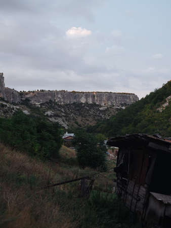 Nature mountains fresh air clouds blue sky houses in the backgroundの写真素材