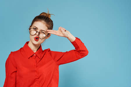 Elegant woman in red shirt official blue backgroundの写真素材