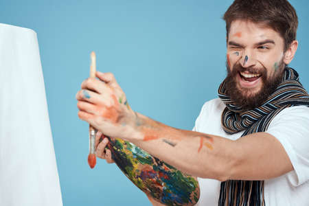 Male artist easel art drawing creativity blue backgroundの写真素材