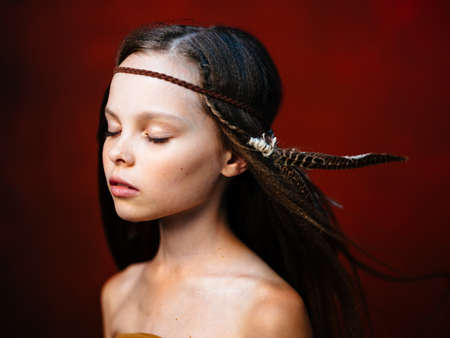 beautiful girl with headdress feather choker closed eyes side view