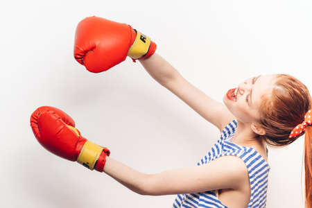 emotional woman in red boxing gloves hairstyle makeup modelの写真素材