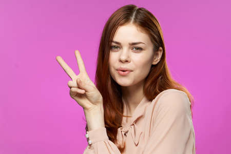 pretty woman gesturing with hands glamor fashion fun pink background close-up