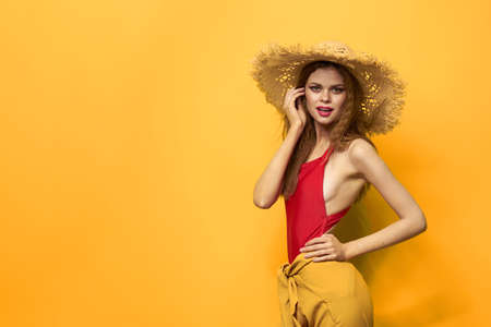 Woman in straw hat bright makeup summer lifestyle fun yellow background