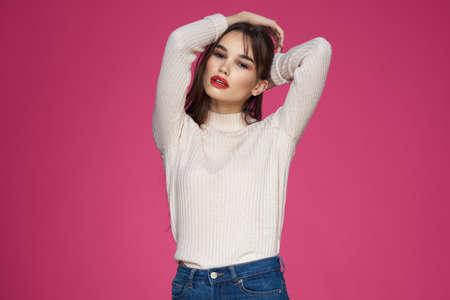 Beautiful brunette long hair fashionable clothes elegant style pink backgroundの写真素材