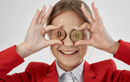 cheerful Business woman in a red jacket cryptocurrency Bitcoin electronic moneyの写真素材