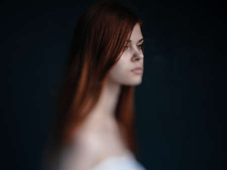 Sexy women red hair bared shoulders dark background model