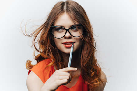 portrait of a woman in a black dress on a green background and glasses on her faceの写真素材