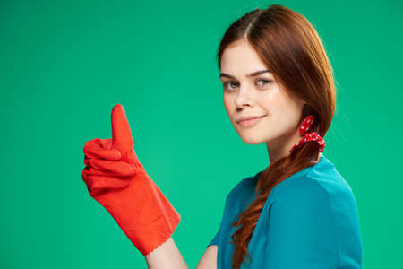 cleaning lady wearing rubber gloves cleaning supplies professional houseworkの写真素材