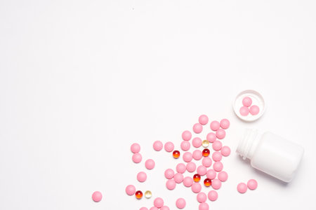 White jar with pills on a light background top view medicine health vitaminsの写真素材