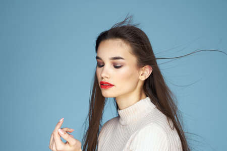 Pretty woman red lips white jacket attractive look close-up blue background