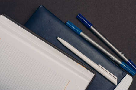 notepads documents books pens desktop gray backgroundの写真素材