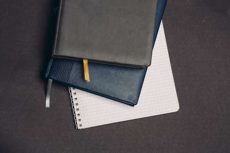 notepads documents books pens desktop gray backgroundの写真素材