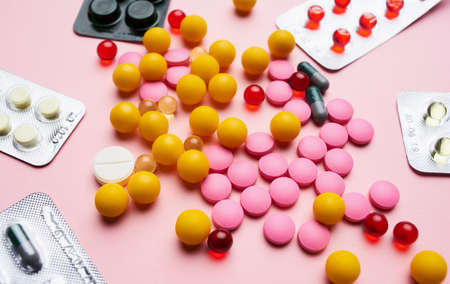 medicine pills vitamins first aid kit pink backgroundの写真素材