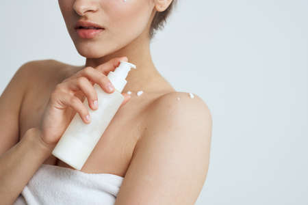 Woman in white shower towel nude women skin lotion care dermatologyの写真素材