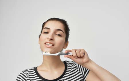 woman in striped t-shirt toothbrush oral hygiene health