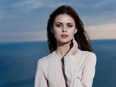 Beautiful woman near the sea in nature in light clothing model oceanの写真素材