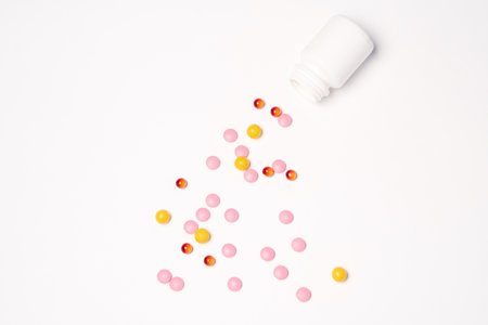 White jar with pills on a light background top view medicine health vitaminsの写真素材
