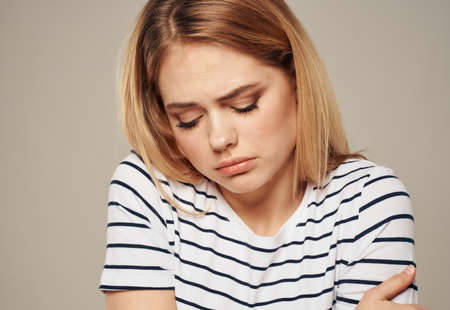 upset woman crying on beige background emotions cropped viewの写真素材