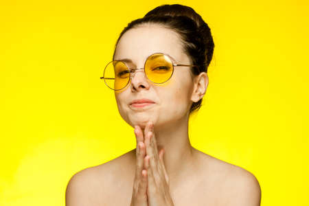 woman with bare shoulders wearing glasses gathered hair smileの写真素材