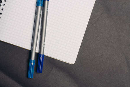 notepad with pens writing office gray background papersの写真素材